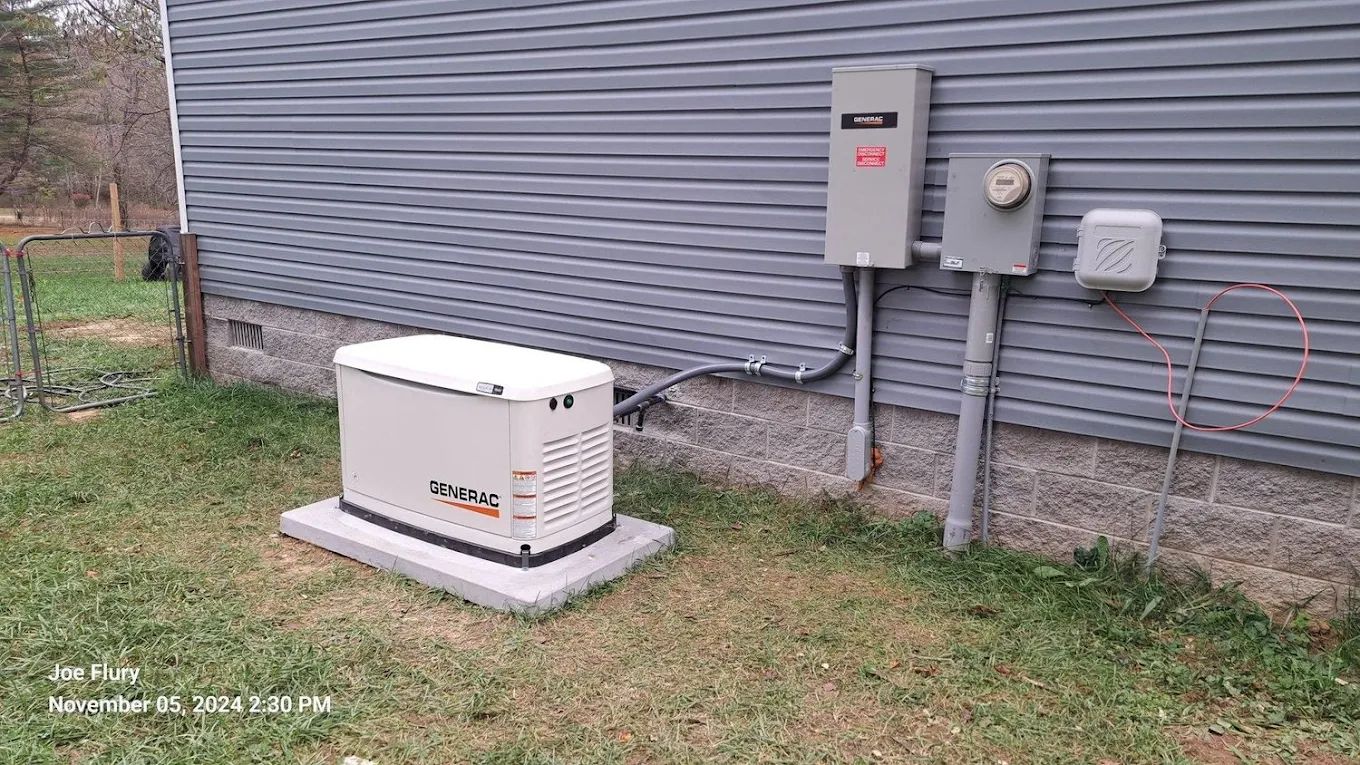 A generator is sitting on the side of a house