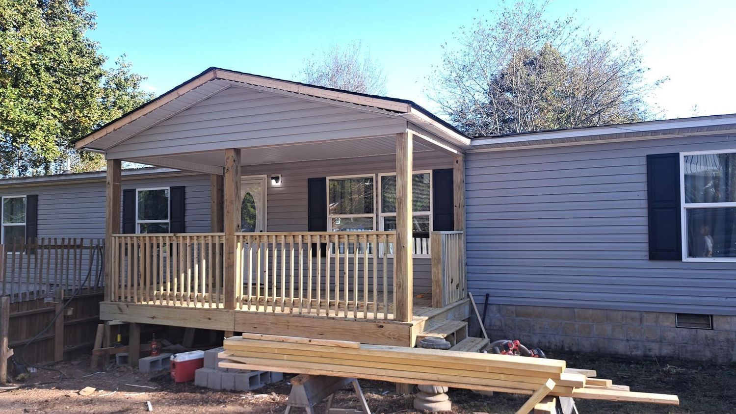 A mobile home with a porch being built on top of it