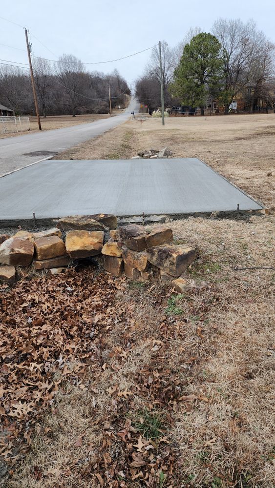 A concrete slab is sitting in the middle of a field next to a road.