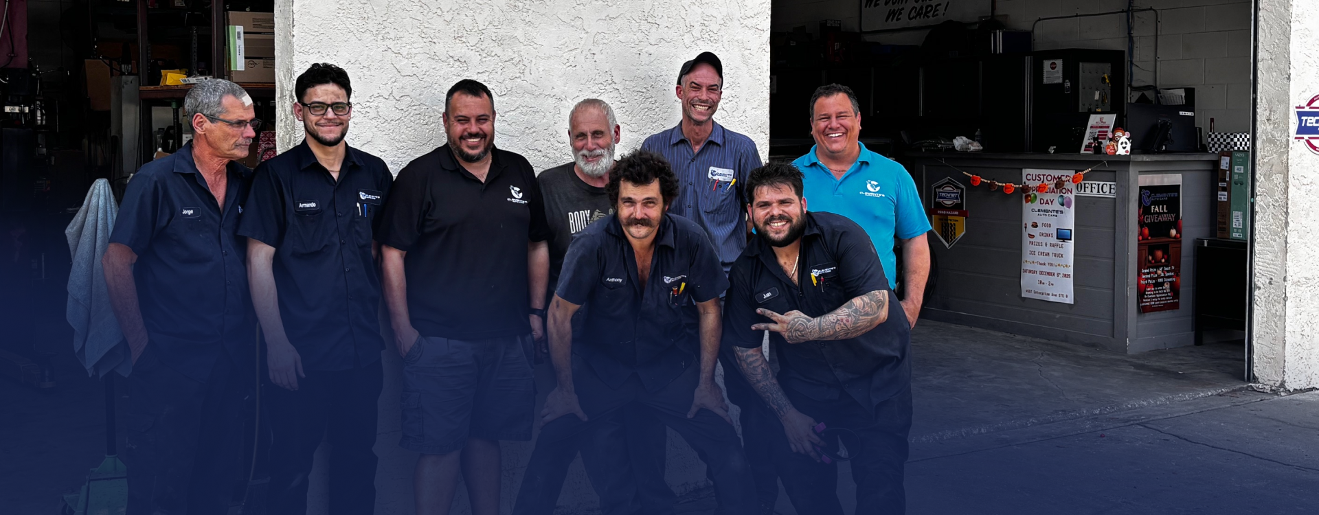 Group of men standing in front of an auto repair shop. They are smiling. | Clemente's Auto Care