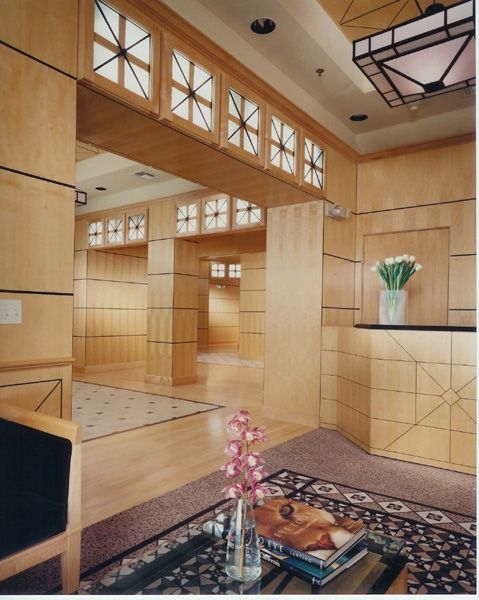 A room with a table and chairs and a vase of flowers