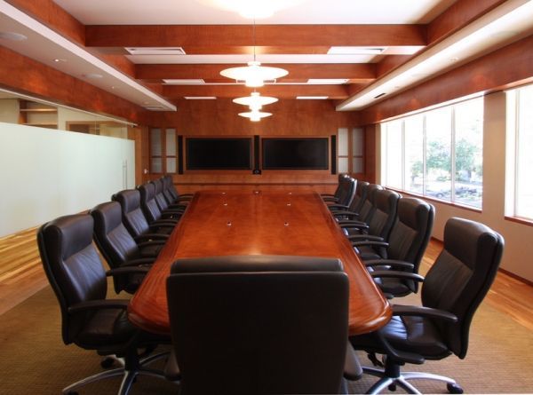 A conference room with a long table and chairs