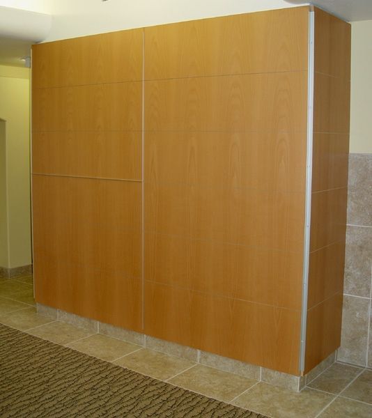 A large wooden wall in a room with tile floors