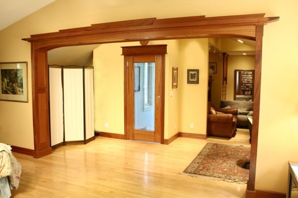 A living room with hardwood floors and a wooden archway