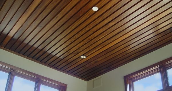 A wooden ceiling with a lot of windows in a room.