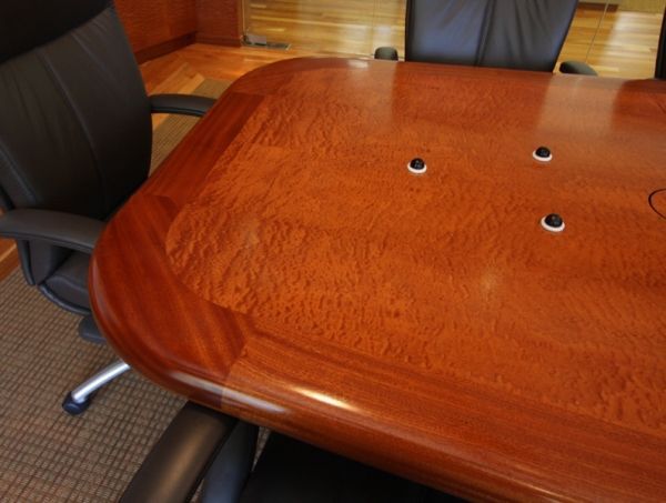 A wooden table with three small holes in it