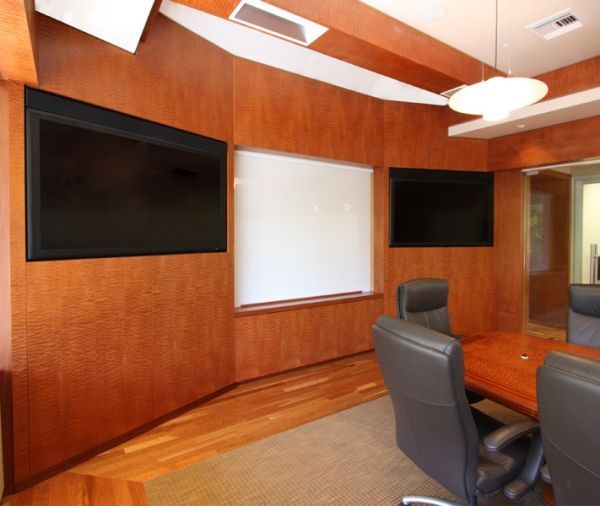 A conference room with a wooden table and chairs