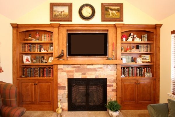 A living room with a fireplace and a flat screen tv