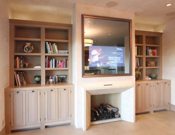 A living room with a fireplace and a large mirror