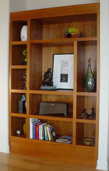 A bookshelf with a picture of a man on it