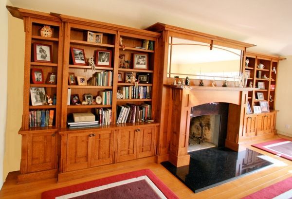 A living room with a fireplace and bookshelves