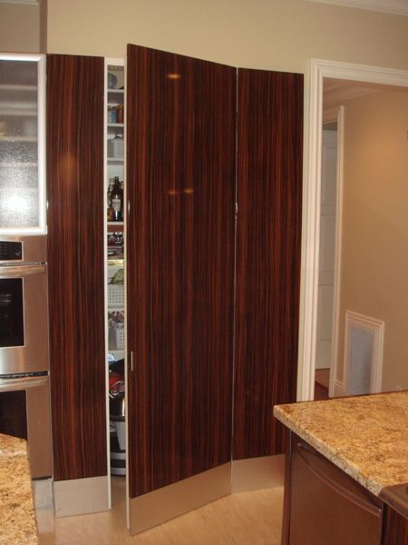 A kitchen with stainless steel appliances and wooden cabinets