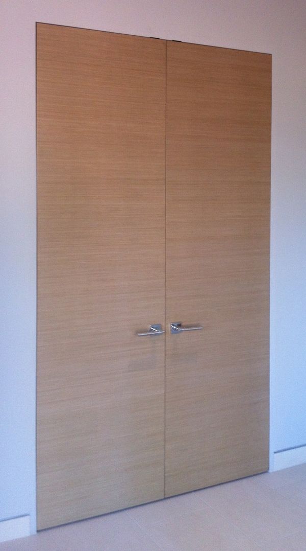 A pair of wooden doors are open in a room.