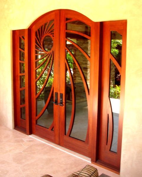 A set of wooden doors with a design on them