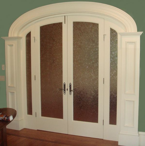 A white door with a green wall behind it