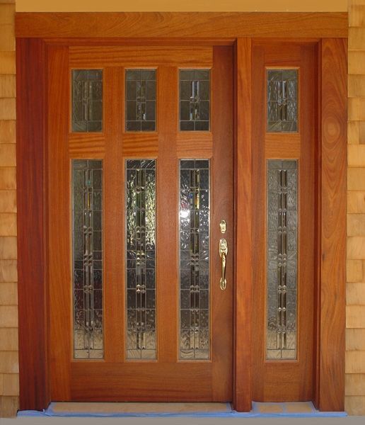 A large wooden door with stained glass windows