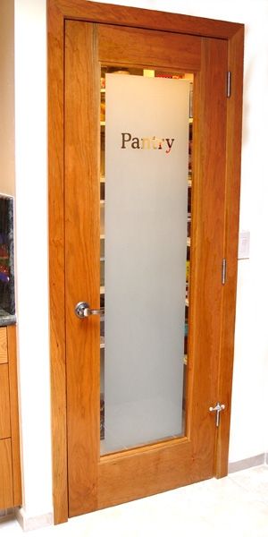 A wooden door with a frosted glass that says party on it