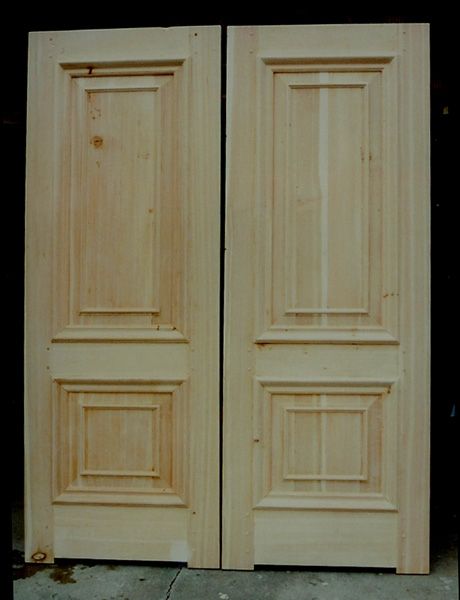 A pair of wooden doors with a black background