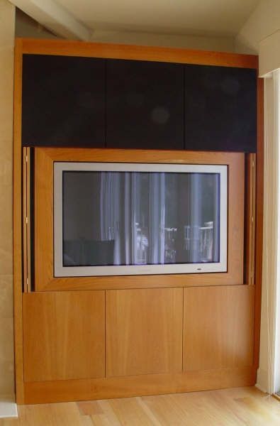 A wooden entertainment center with a flat screen tv