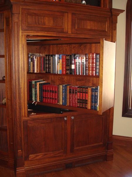 A wooden bookcase with lots of books on it