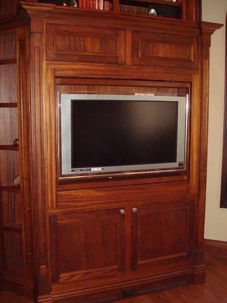 A wooden entertainment center with a flat screen tv