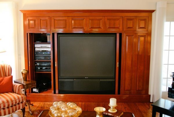 A living room with a large flat screen tv on the wall