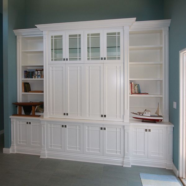 A room with lots of white cabinets and shelves