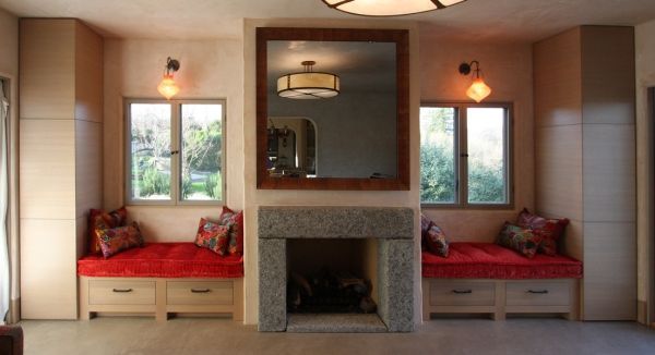 A living room with a fireplace and a mirror