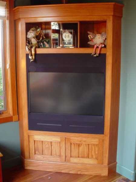 A wooden entertainment center with a flat screen tv