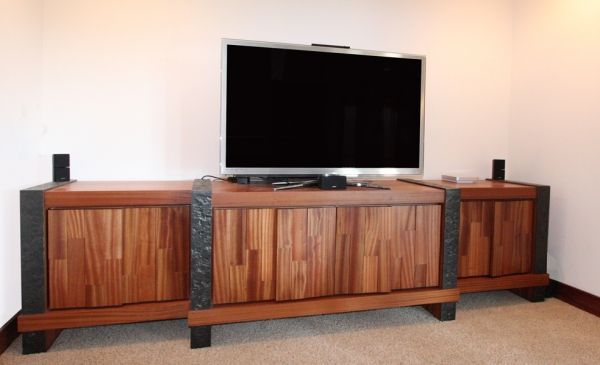 A flat screen tv is sitting on top of a wooden entertainment center.