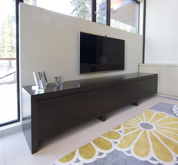 A living room with a large flat screen tv on the wall