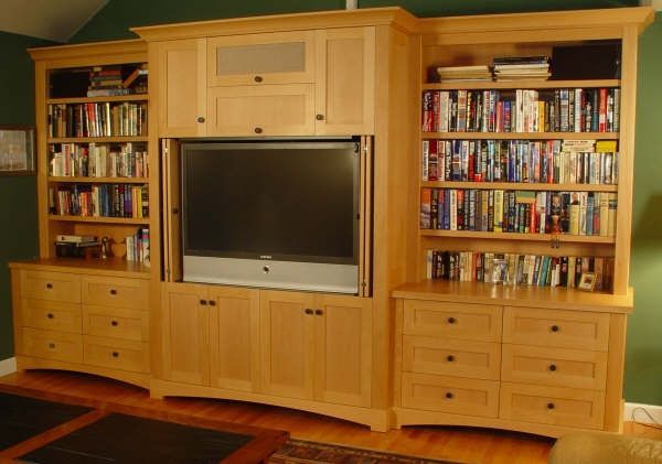 A living room filled with books and a flat screen tv