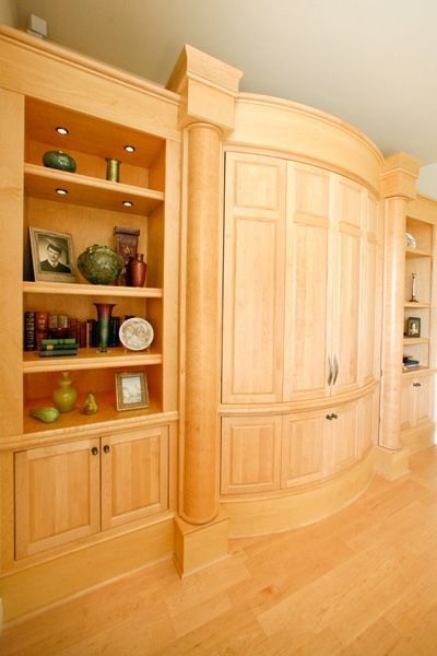 A room with a lot of wooden cabinets and shelves