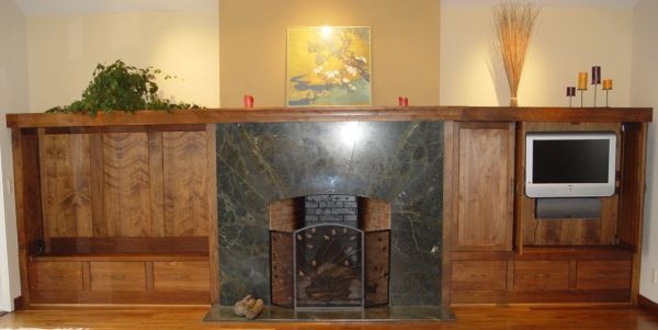 A living room with a fireplace and a flat screen tv