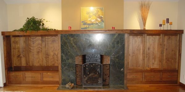 A living room with a fireplace and a painting on the wall