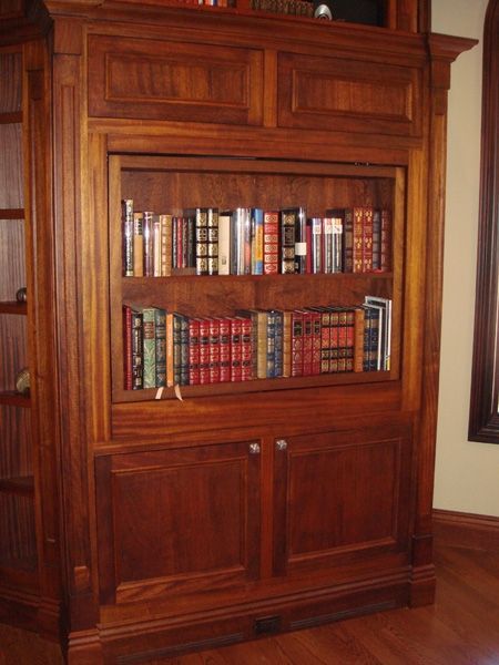 A large wooden bookcase filled with lots of books