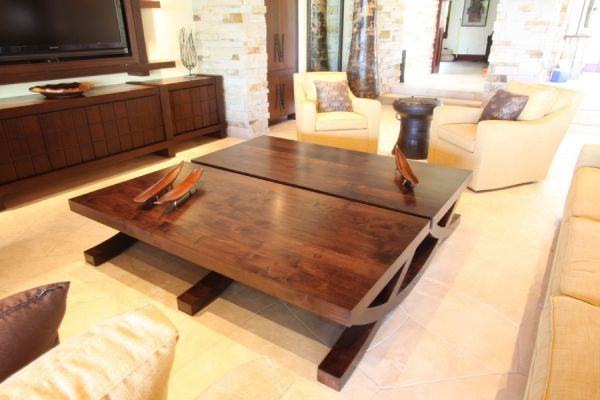 A living room with a coffee table and a flat screen tv