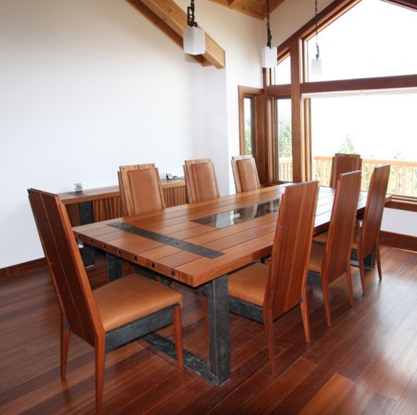 A dining room with a wooden table and chairs