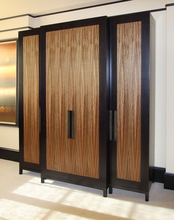 A row of wooden cabinets in a room with a picture on the wall