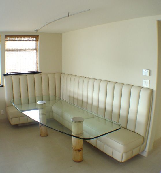 A room with a couch and a glass table