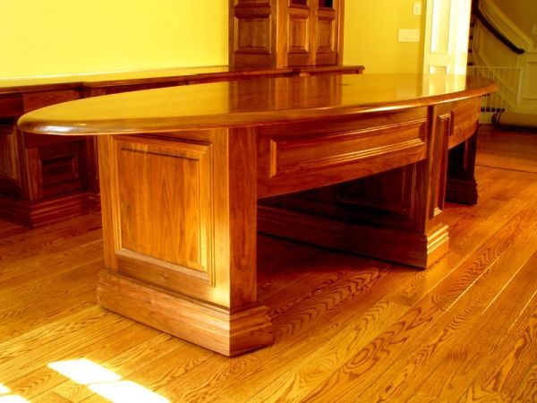 A wooden table is sitting on a wooden floor in a room