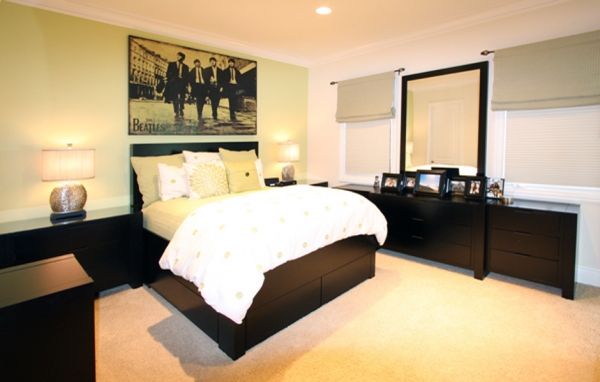 A bedroom with a large bed and a picture on the wall above it