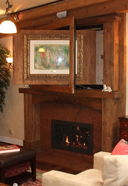 A living room with a fireplace and a picture on the wall