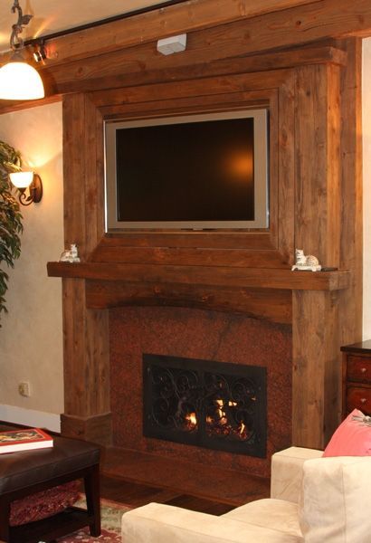A living room with a fireplace and a flat screen tv