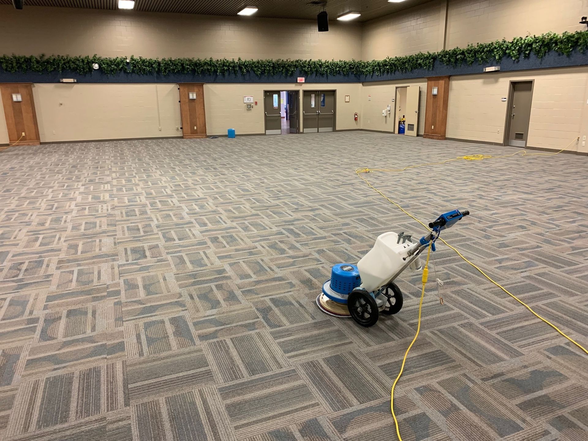 A machine is sitting on the floor of a large room.