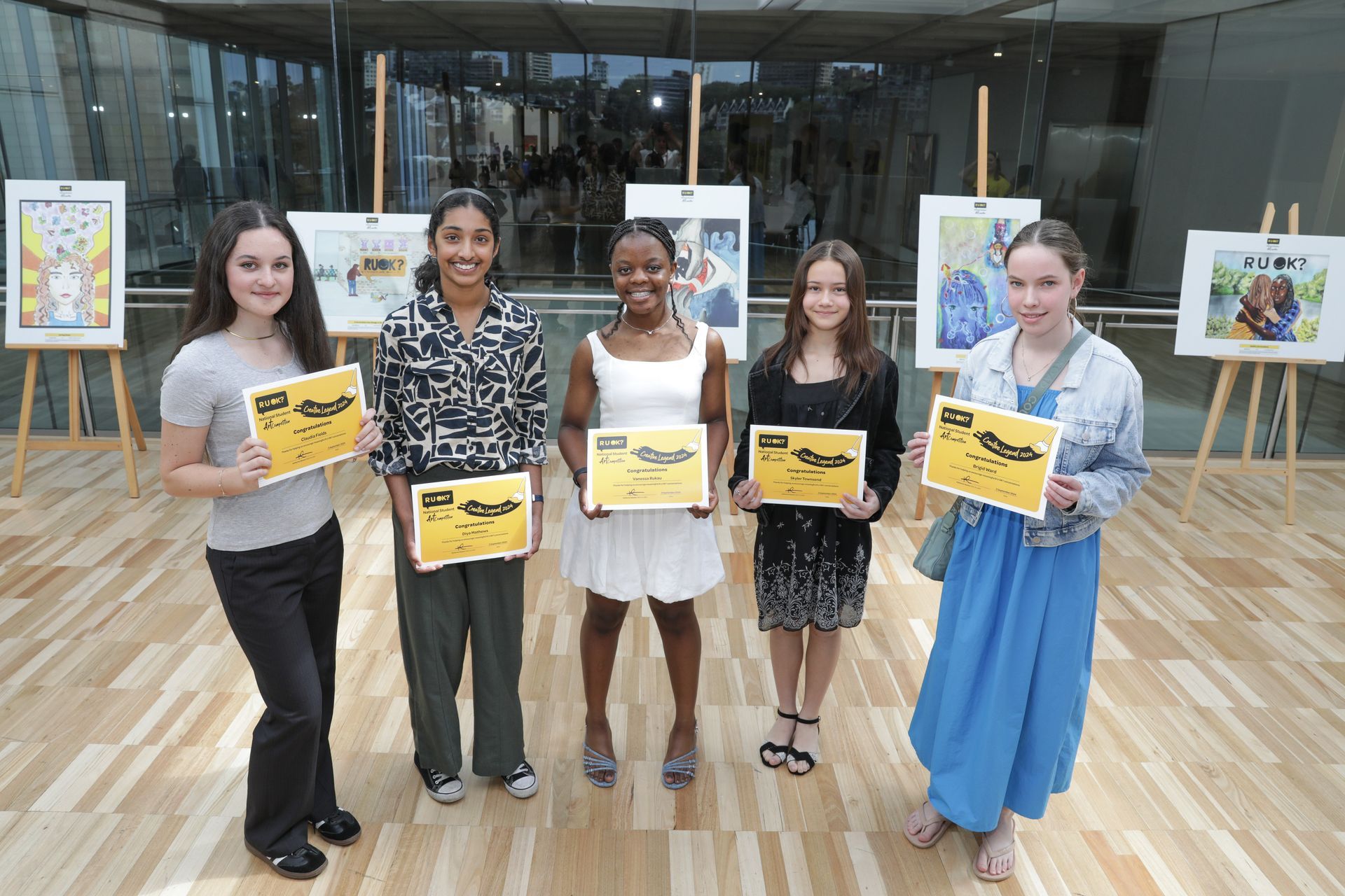 The art competition winners hold up their certificates.