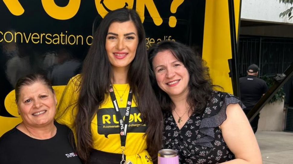Nazik, in a yellow t shirt, at an R U OK? event.