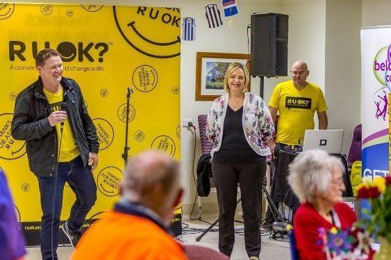 Man speaking to group at an R U OK? Day event