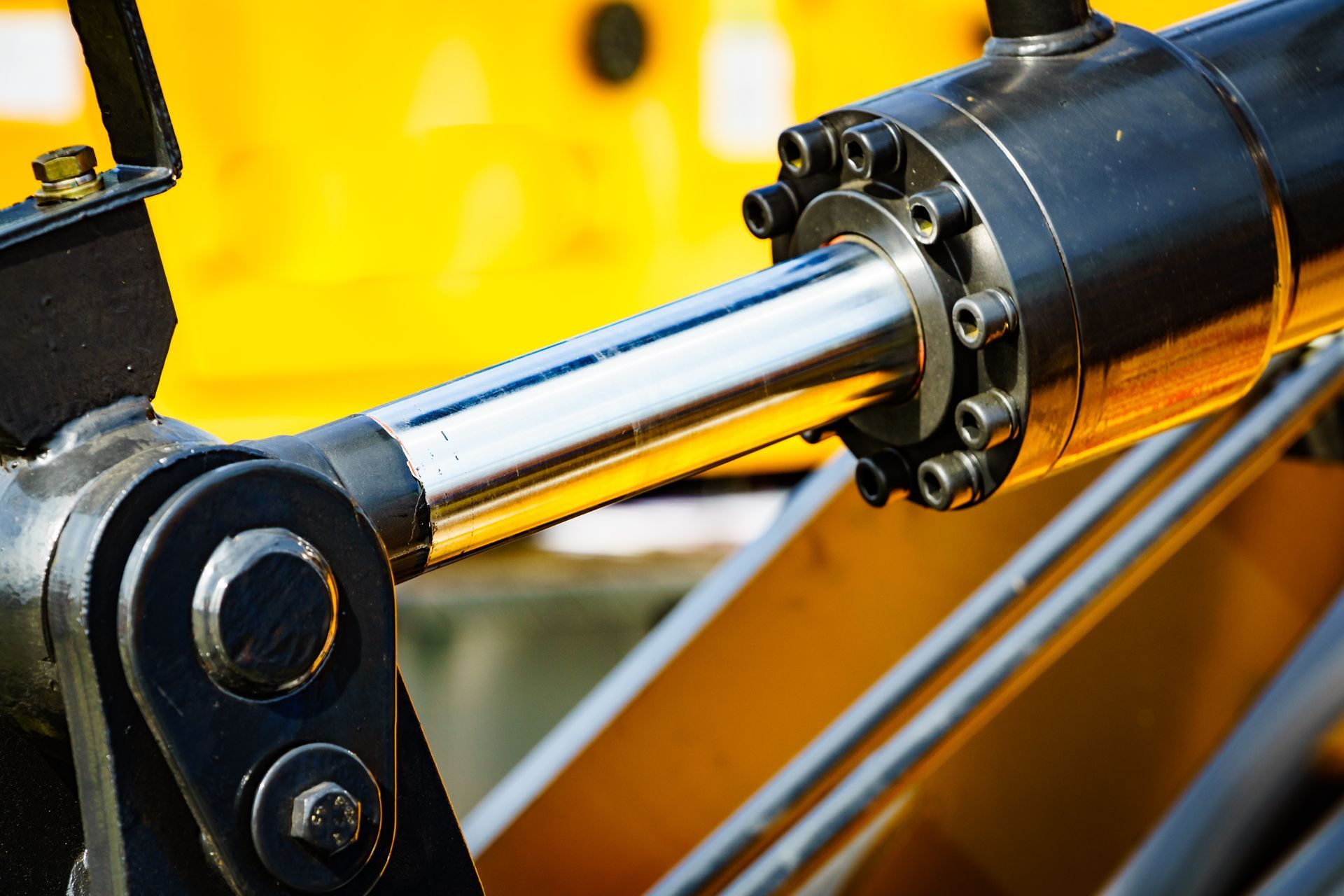Close-up of a hydraulic cylinder on heavy construction equipment.