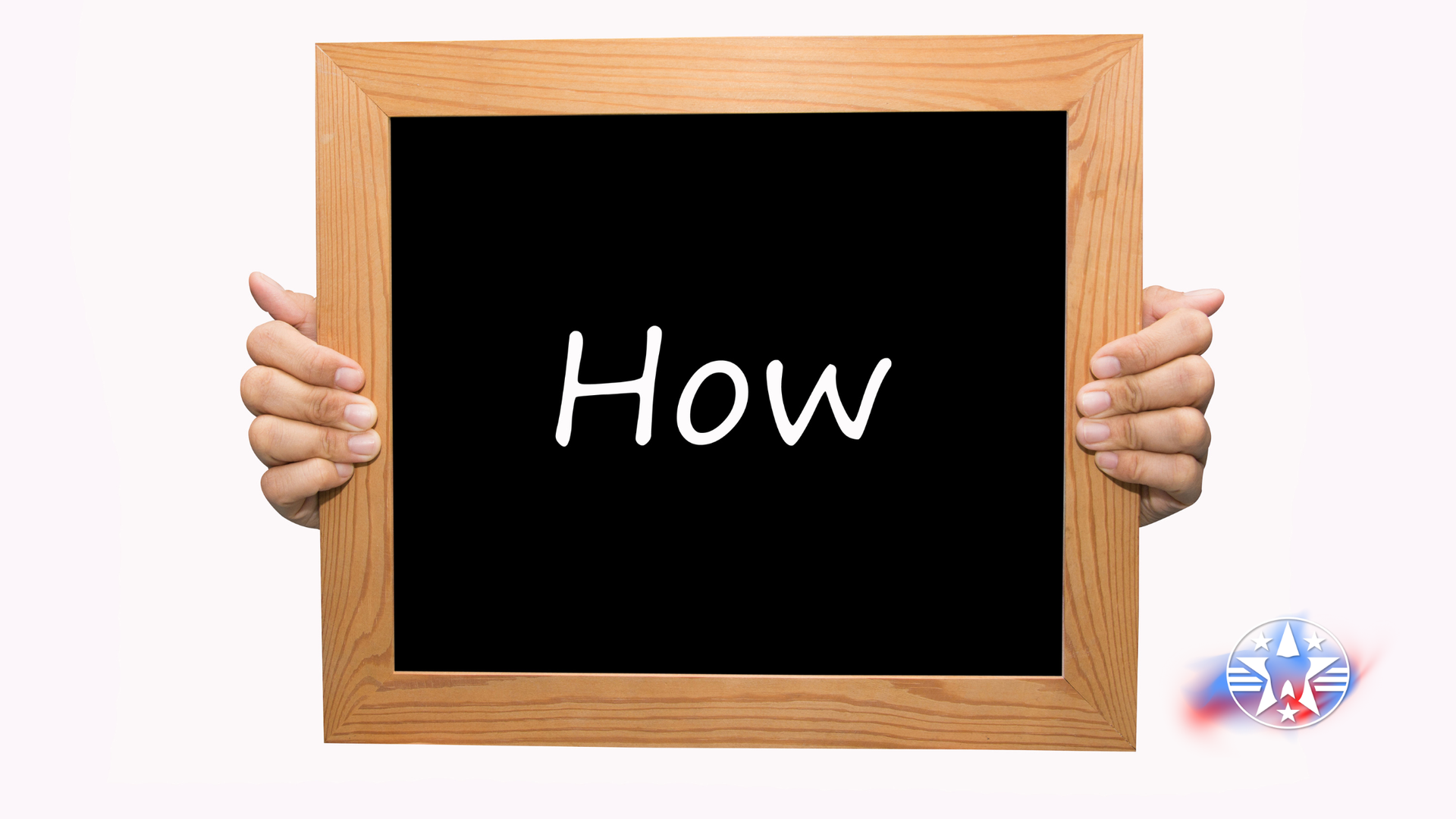 Hands holding a wooden-framed chalkboard with the word 